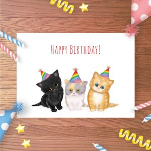 Greetings card with three cute kittens wearing rainbow party hats.