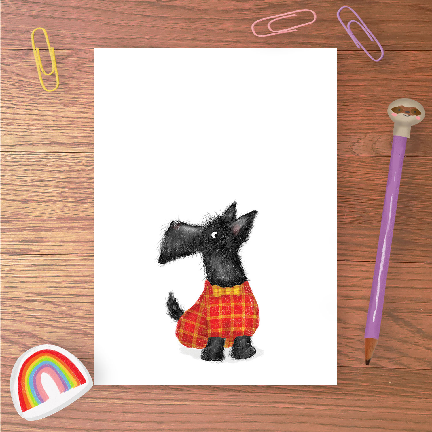 Greetings card with a Scottie dog wearing a red and yellow tartan coat and bowtie.