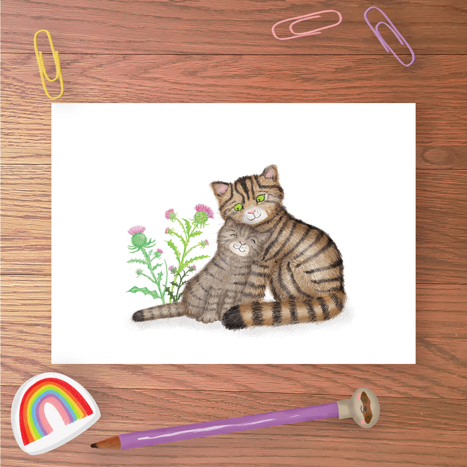 Greetings card with mother Scottish wildcat and kitten with thistles in the background.