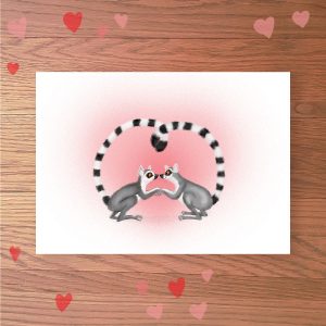 Greetings card with two lemurs holding hands, with their tails entwined in a heart shape.