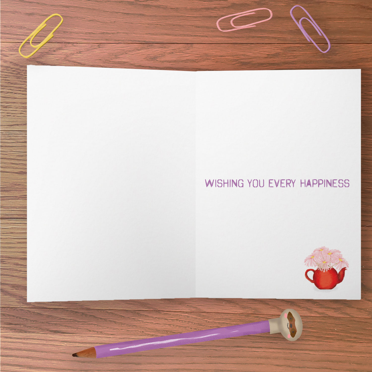 inside of a greetings card with 'Wishing you every happiness' message and a drawing of a teapot fiull of pink flowers.