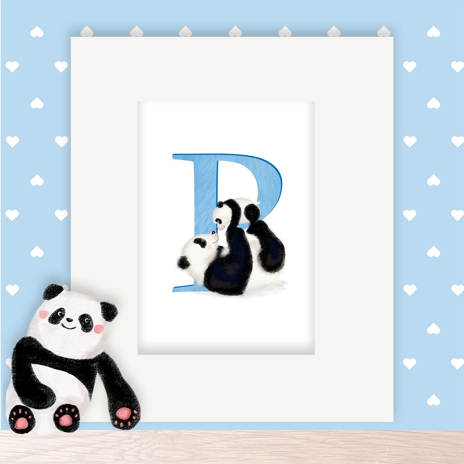 Blue letter P with a mother and baby panda, in a mount on a shelf next to a toy panda.