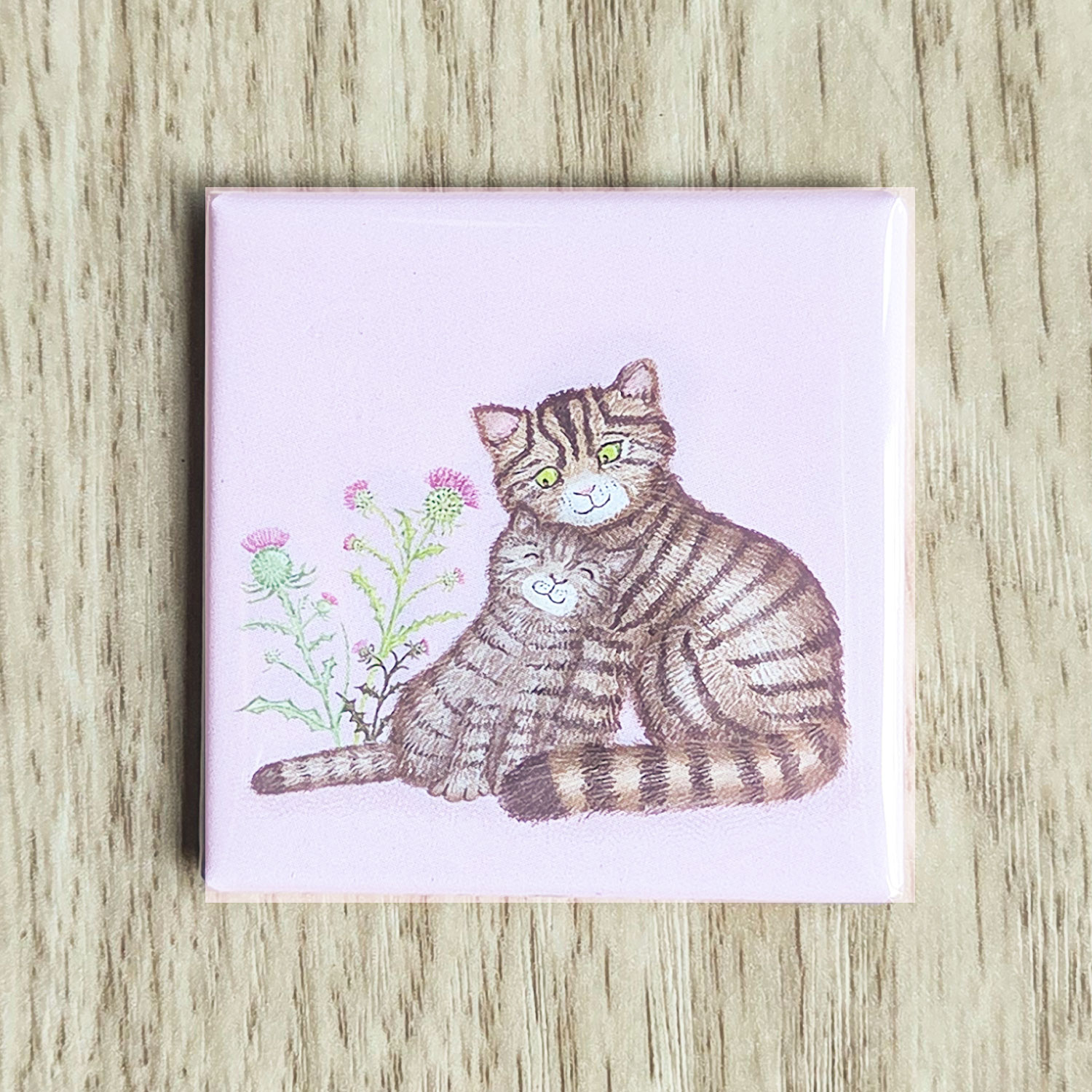 Square magnet with a cute Scottish wildcat and kitten on a lilac background.