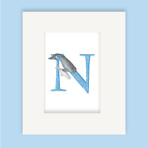 Mounted print hanging on the wall, of a blue capital letter M with a cute father and baby narwhal swimming together.