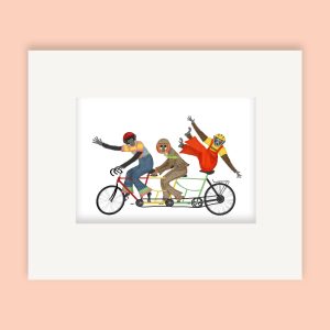 Mounted print hanging on a wall, of 3 gibbons wearing brighly coloured outfits, balancing on a bicycle made for three.