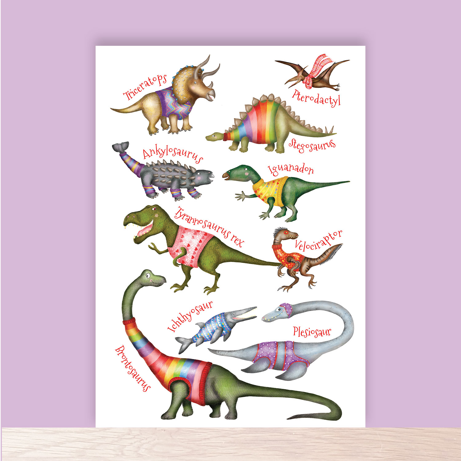 Print of cute dinosaurs wearing colourful jumpers.