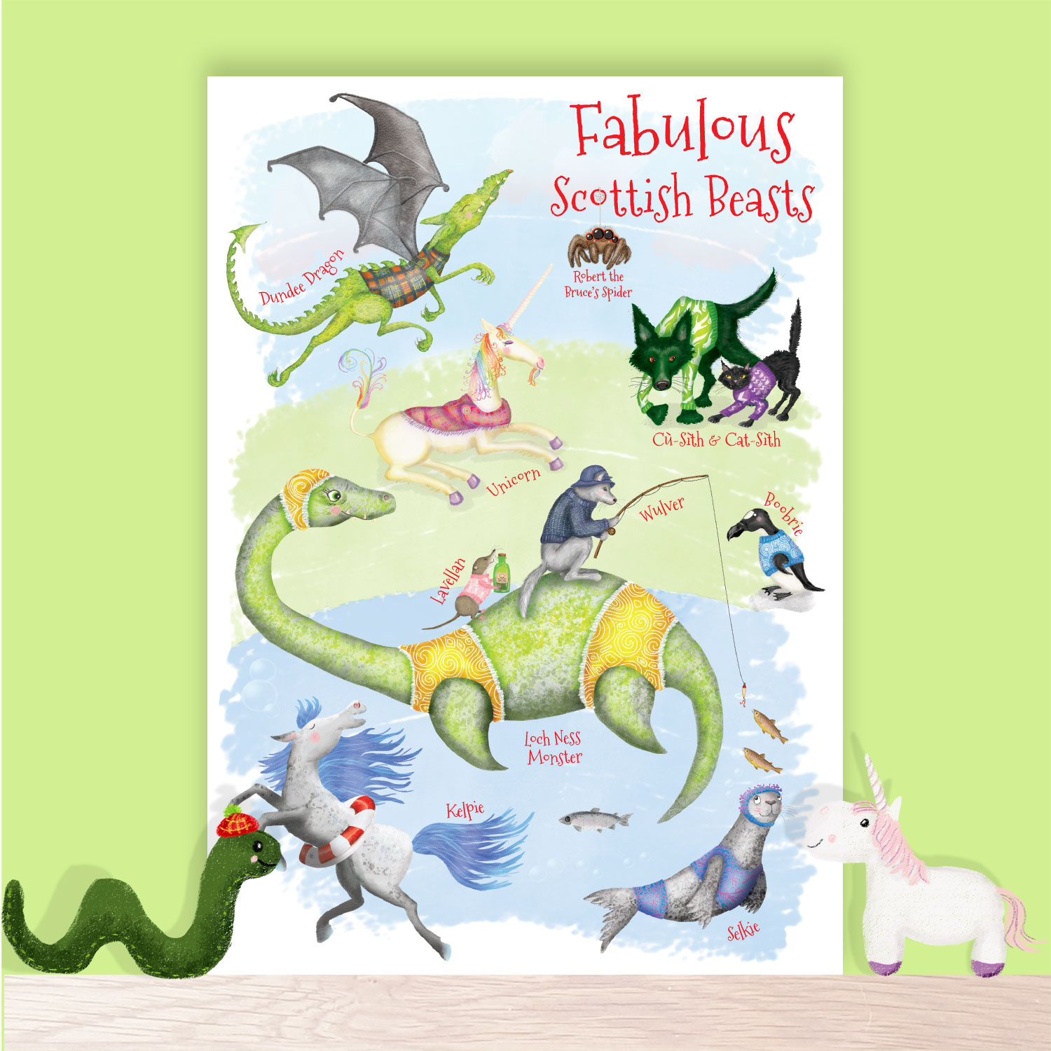 Print of fabulous Scottish beasts including the Loch Ness Monster, Kelpie and Selkie, sitting on a shelf with a toy Nessie and unicorn.