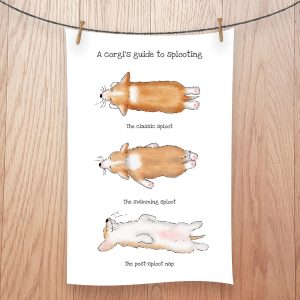 Tea towel featuring three corgi puppies splooting.