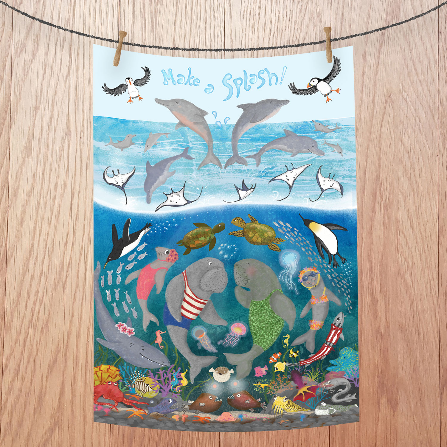 Tea towel with lots of different sea creatures leaping and swimming.