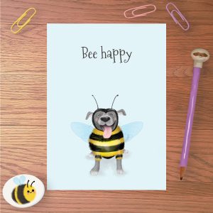 Greetings card with a Staffy dressed as a bee and 'Bee happy' written above.