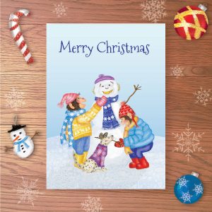 Greetings card with two chimps and a dog building a snow chimp, with Merry Christmas written above.