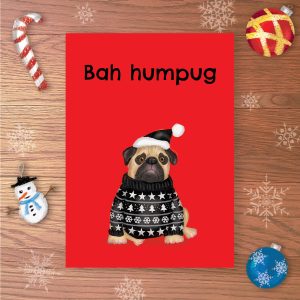 Christmas card with a sad pug wearing a black Christmas jumper and black Santa hat, with Bah humpug written above.