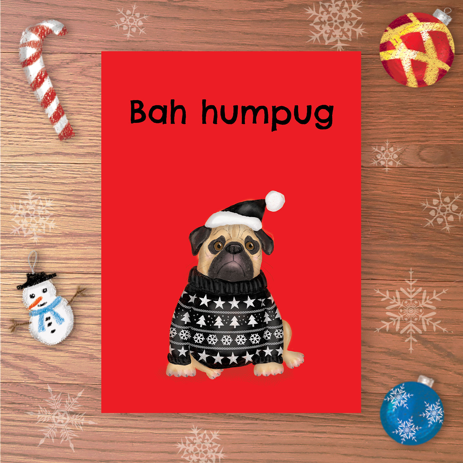 Christmas card with a sad pug wearing a black Christmas jumper and black Santa hat, with Bah humpug written above.