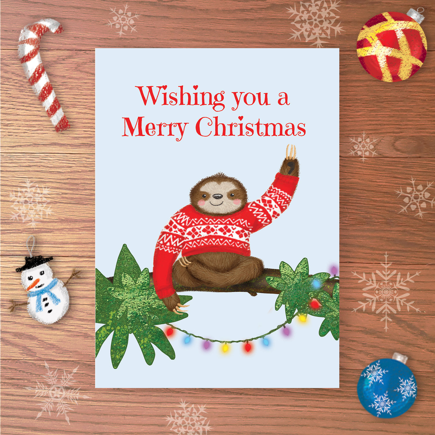 Christmas card with sloth on a branch, waving, wearing a red Christmas jumper and Wishing you a Merry Christmas written above.