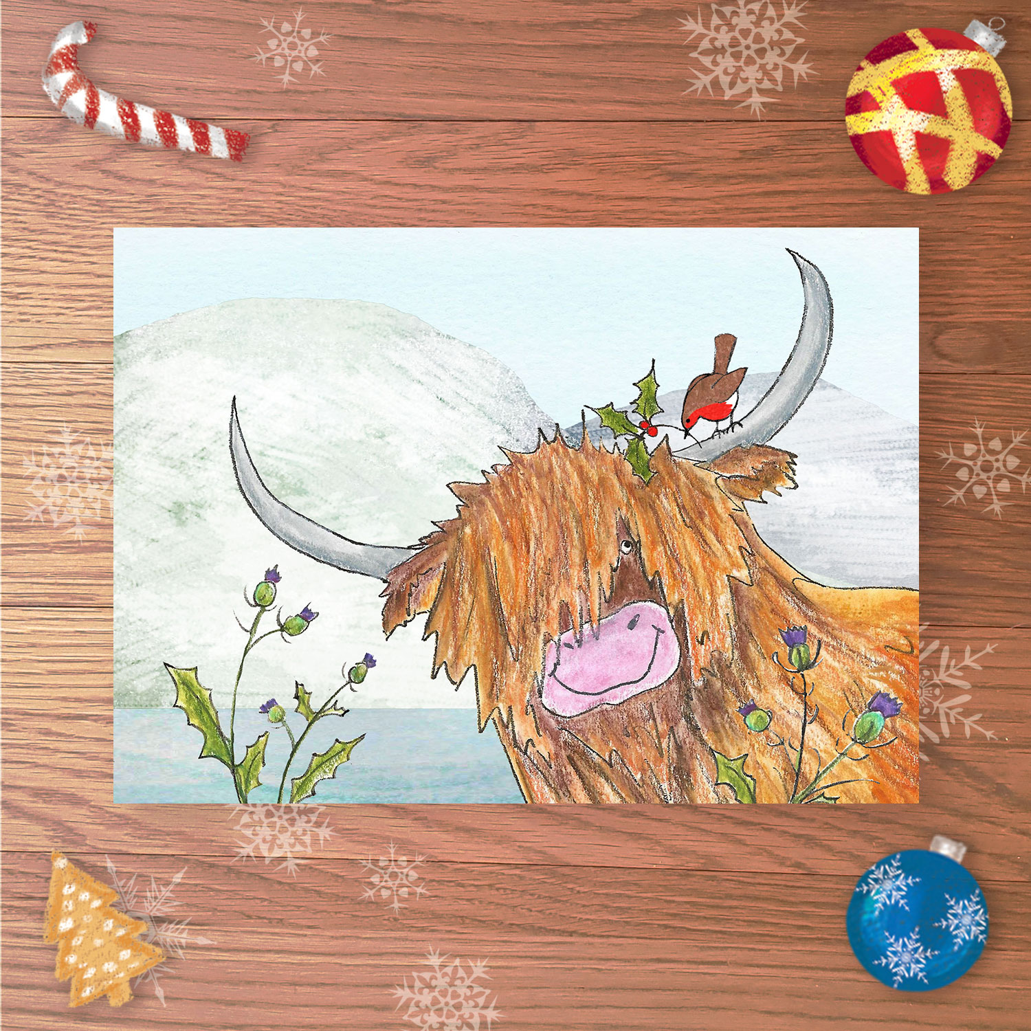 Christmas card with a Highland cow and robin in a snowy landscape.