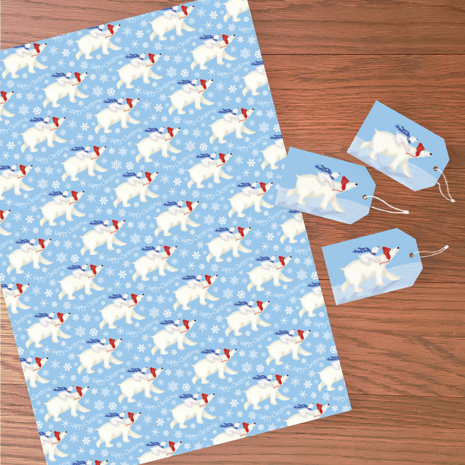 Sheet of Christmas wrapping paper with a polar bear and cub design, with three matching tags.