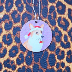 Hanging decoration featuring a cute corgi wearing a Santa hat, with a corgi decoration in her mouth.