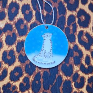 Christmas hanging decoration with a cute snow leopard surrounded by snowflakes.